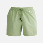 "Decoupage image of Louis mint green mid-thigh length men's swim shorts by Moeva, showcasing multiple angles and details. Highlighting the ultra-light, quick-dry fabric, elastic waistband, drawstrings with black nickel stoppers, Moeva patch, and two open pockets. Perfect for creating a stylish and comfortable beachside look."