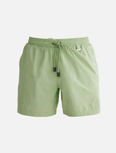 "Decoupage image of Louis mint green mid-thigh length men's swim shorts by Moeva, showcasing multiple angles and details. Highlighting the ultra-light, quick-dry fabric, elastic waistband, drawstrings with black nickel stoppers, Moeva patch, and two open pockets. Perfect for creating a stylish and comfortable beachside look."