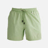 "Decoupage image of Louis mint green mid-thigh length men's swim shorts by Moeva, showcasing multiple angles and details. Highlighting the ultra-light, quick-dry fabric, elastic waistband, drawstrings with black nickel stoppers, Moeva patch, and two open pockets. Perfect for creating a stylish and comfortable beachside look."