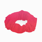 Peggy Red Gradient Scrunchie laid flat, displaying the vibrant red gradient and soft swimwear fabric.
