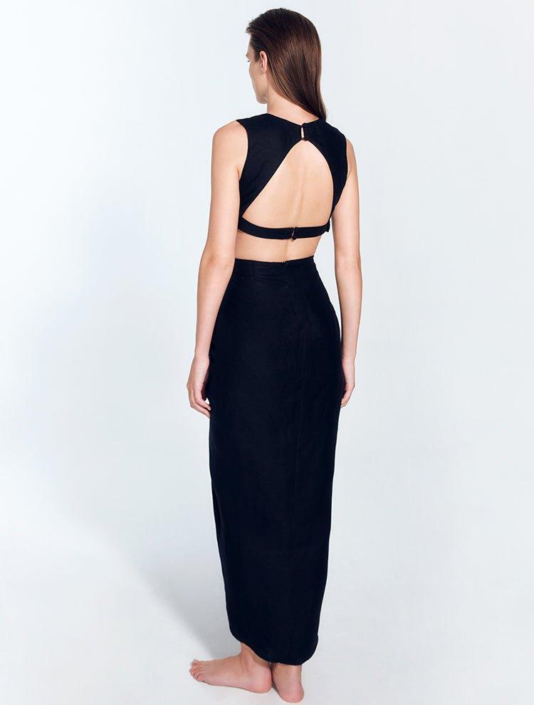 "Back view of Adelice black dress featuring an open back with side cutouts, showcasing a flirty and feminine silhouette."