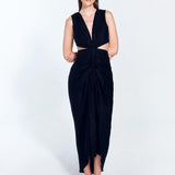 " Front view of Adelice black dress with a deep V neckline, center ruching, asymmetrical skirt, high front slit, and side cutouts."