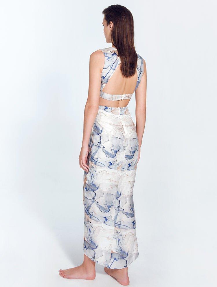 "Back view of Adelice blue abstract dress featuring an open back with side cutouts, highlighting a flirty and feminine silhouette."