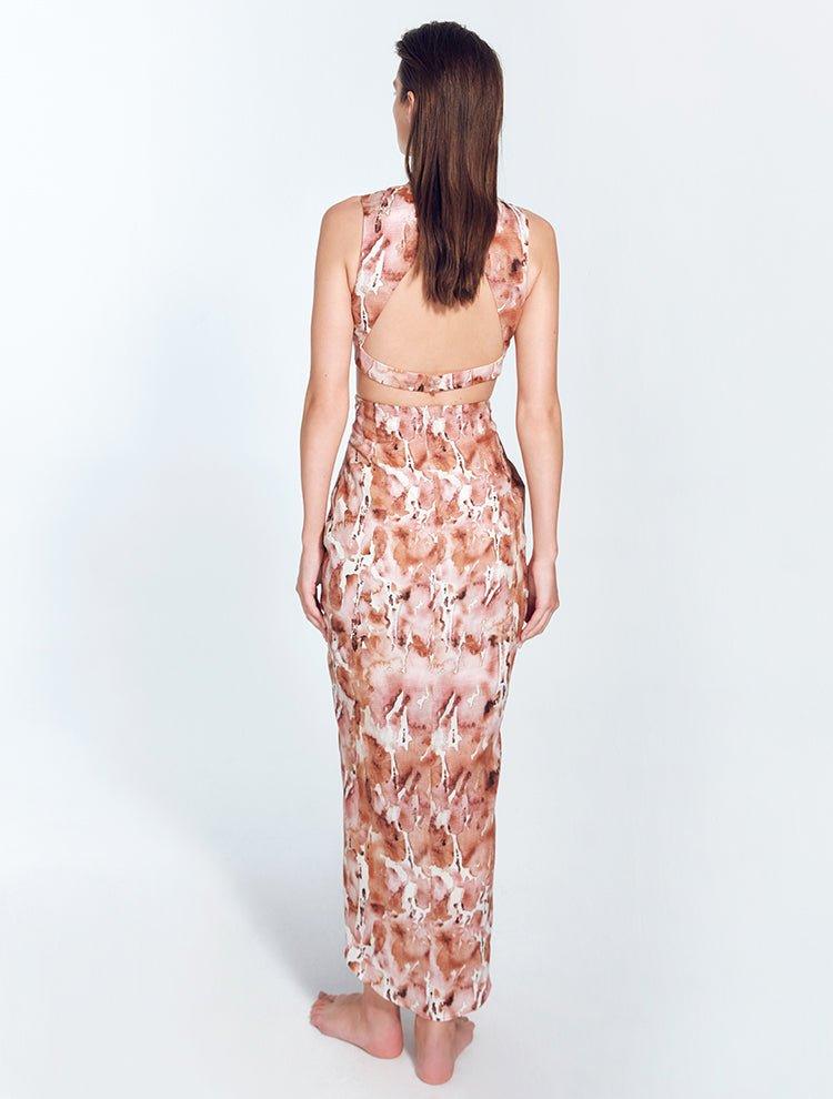 "Back view of Adelice floral abstract dress featuring an open back with side cutouts, showcasing a flirty and feminine silhouette."
