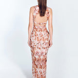 "Back view of Adelice floral abstract dress featuring an open back with side cutouts, showcasing a flirty and feminine silhouette."