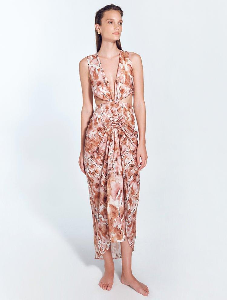 " Front view of Adelice floral abstract dress with deep V neckline, center ruching, asymmetrical skirt, high front slit, and side cutouts."