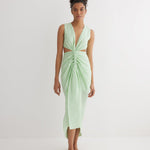 "Front view of the Adelice Mint Green Dress featuring a deep V neckline, ruching, high front slit, and asymmetrical skirt."