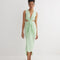 "Front view of the Adelice Mint Green Dress featuring a deep V neckline, ruching, high front slit, and asymmetrical skirt."