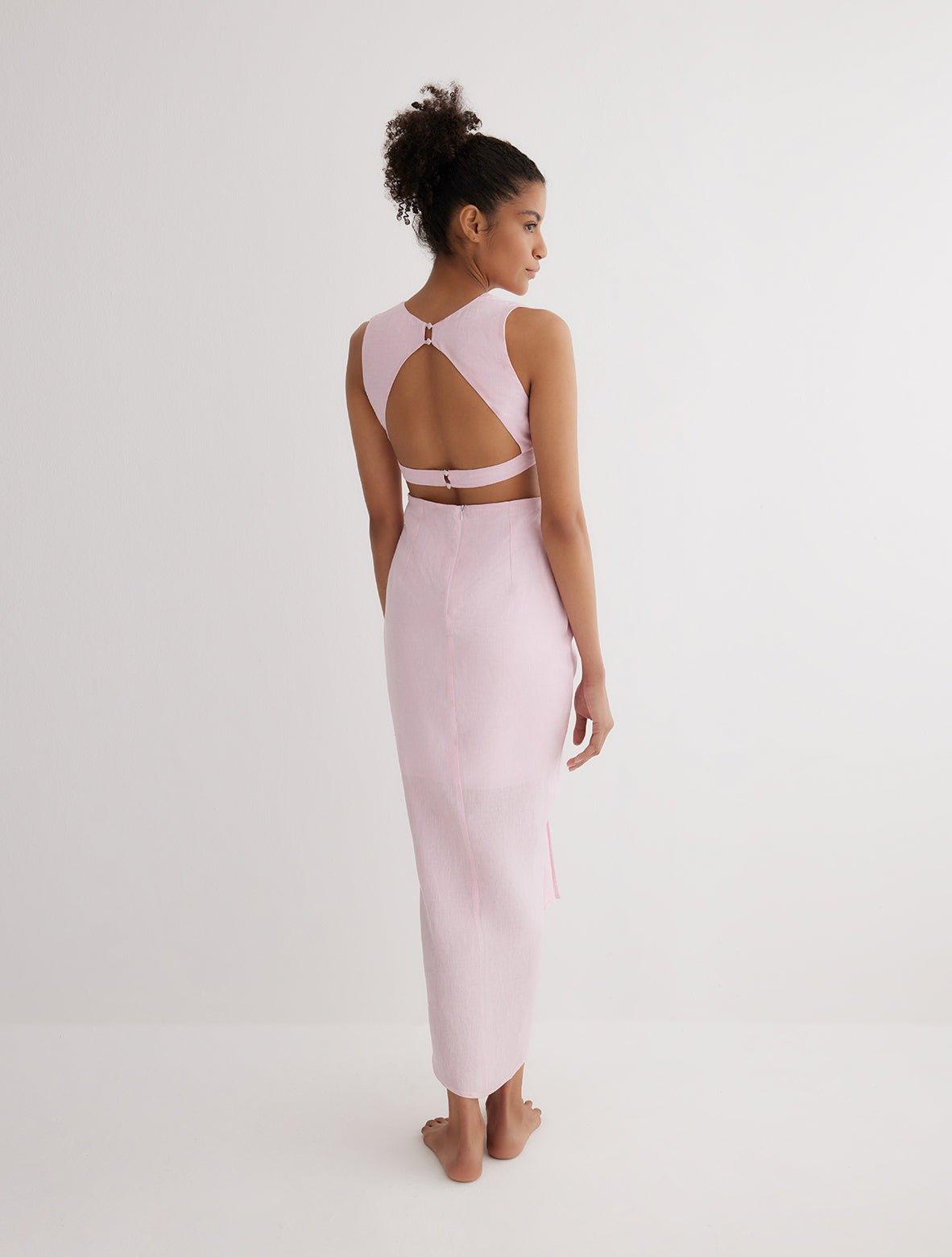 "Back view of the Adelice Pink Dress highlighting the open back and side cutouts that create an elegant silhouette."