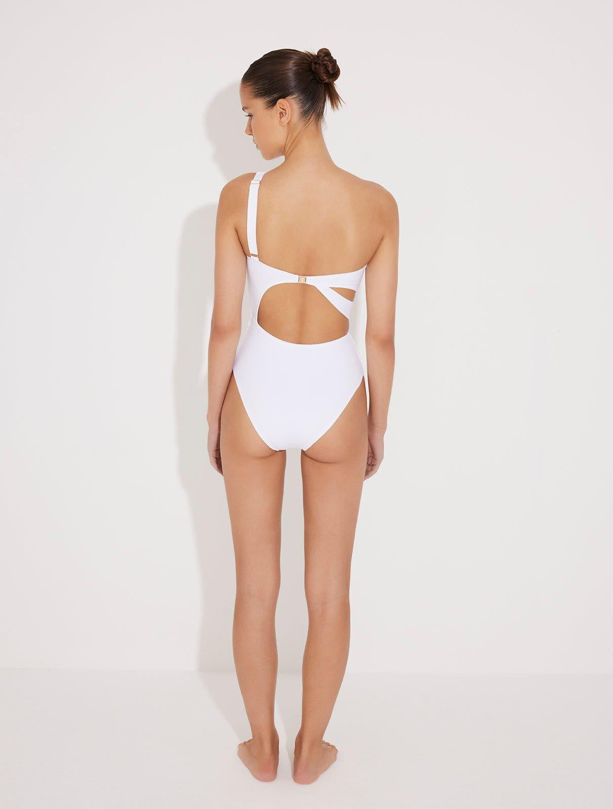 Back View: Model in Adelina White Swimsuit  - MOEVA Luxury Swimwear, Asymmetric Cutouts Accented With Drapes, One Shoulder, Gold Clasps at the Back, Rectangular Accessories, Moderate Bottom Coverage, One Piece Swimsuit, MOEVA Luxury Swimwear 