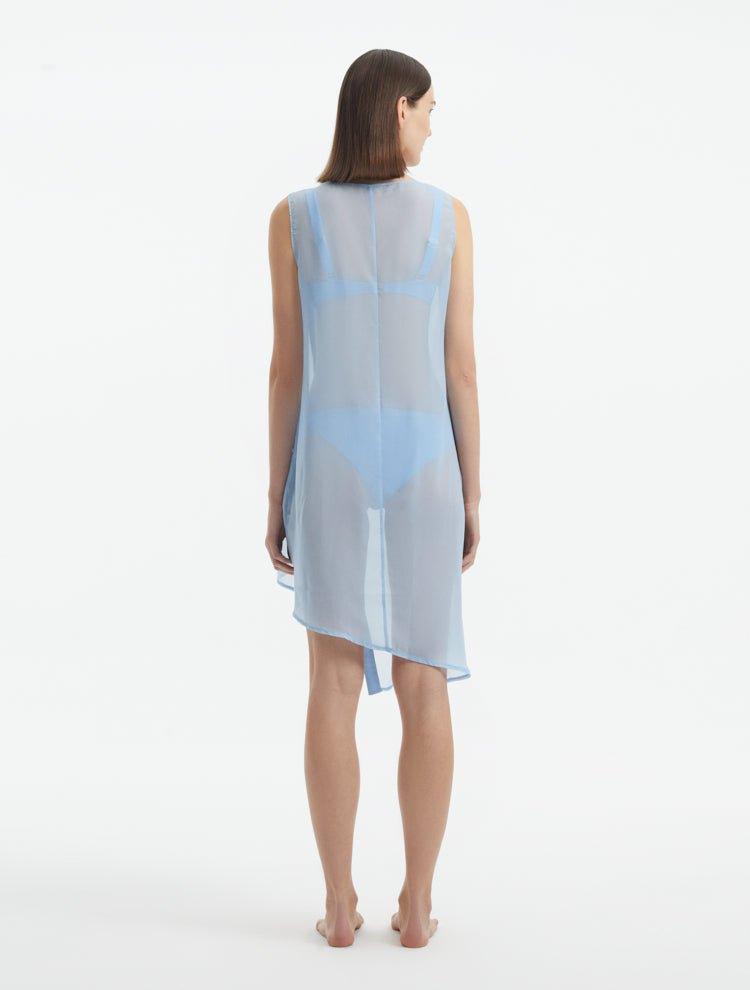 Back view of the Adora baby blue cover-up dress showing the knee-length cut and sheer fabric details.