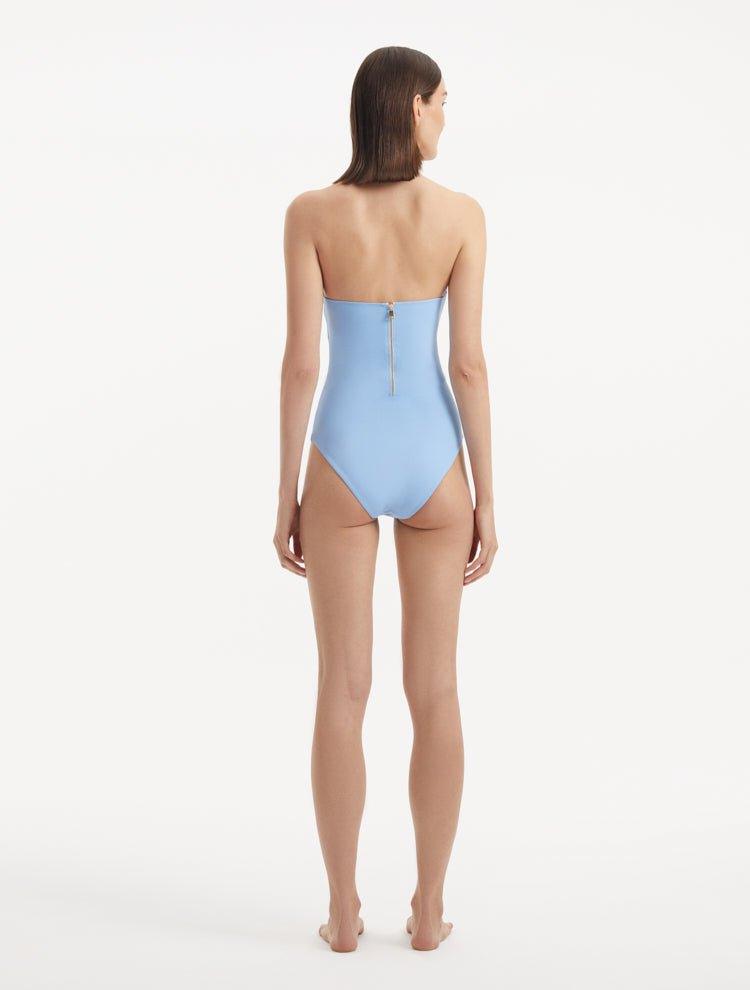 Back view of Adria Blue Swimsuit highlighting the sleek zip closure and adjustable straps. The image emphasizes the full bottom coverage and the sophisticated design of the premium Italian fabric