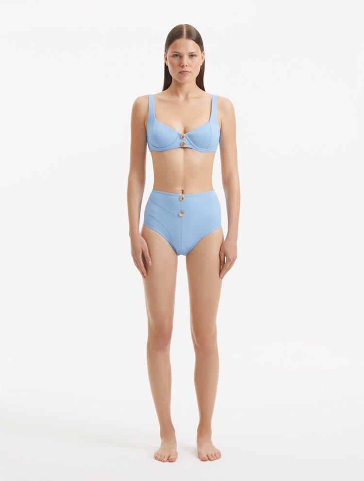 Model showcasing the Adva Baby Blue Bikini Bottom, highlighting the high-waisted design and serene blue color.