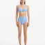 Model showcasing the Adva Baby Blue Bikini Bottom, highlighting the high-waisted design and serene blue color.