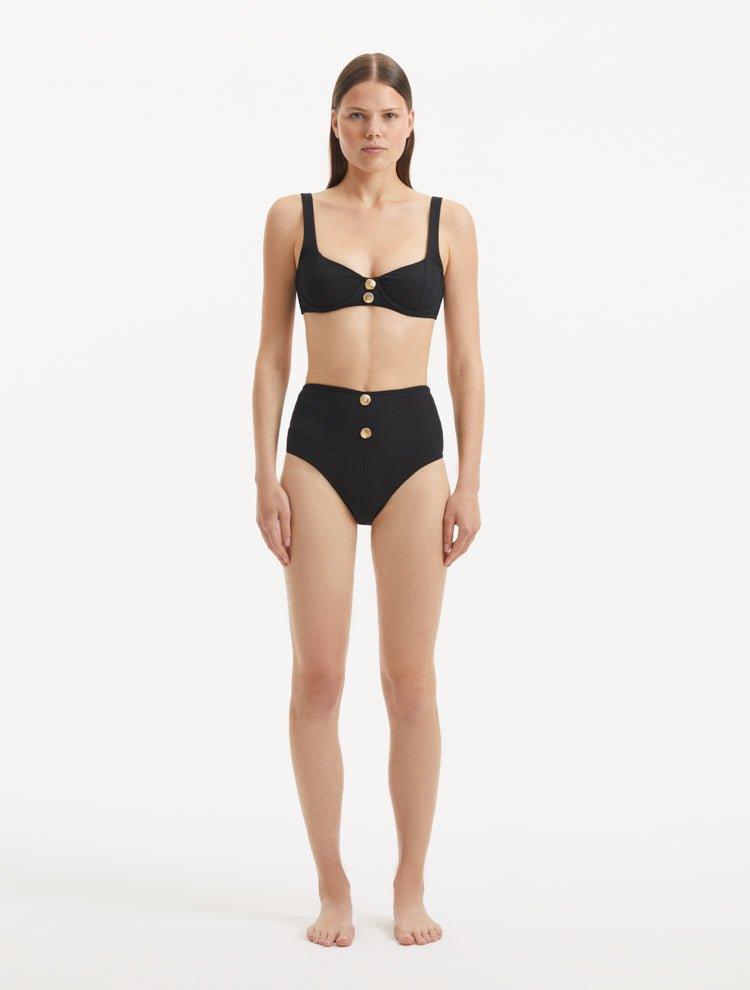 Model wearing the Adva Black Bikini Bottom, highlighting the high-waist design and sophisticated style.