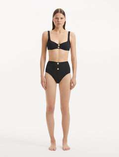 Model wearing the Adva Black Bikini Bottom, highlighting the high-waist design and sophisticated style.