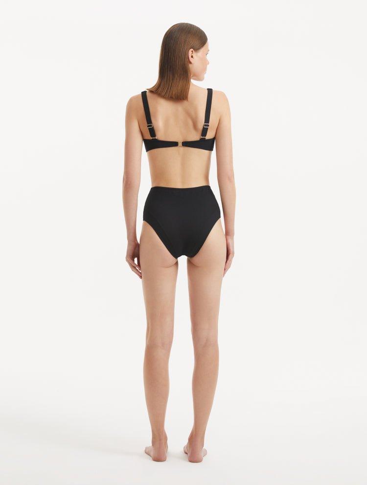 Rear view of the Adva Black Bikini Bottom, showcasing the chic silhouette and moderate coverage.