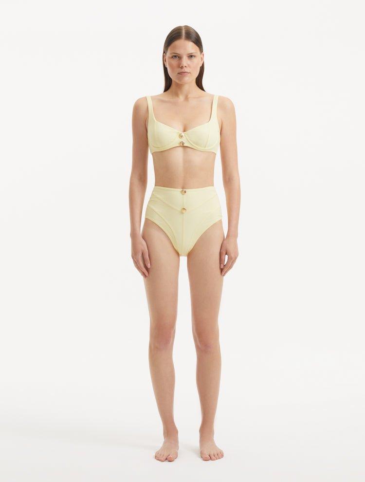  Rear view of the Adva Yellow Bikini Bottom, highlighting its vibrant yellow color and elegant silhouette.