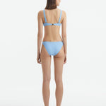 Rear view of the Aeron Baby Blue Bikini Top, highlighting the elegant cut and luxurious Italian fabric.