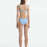 Rear view of the Aeron Baby Blue Bikini Top, highlighting the elegant cut and luxurious Italian fabric.