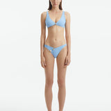  Aeron Baby Blue Bikini Top with scoop neck design, featuring shell-shaped gold button details.