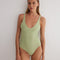 "Front view of Agneta Green/Nude Reversible Bodysuit highlighting its modern design and moderate coverage."