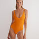 "Model wearing the Agneta Orange/Pink reversible bodysuit from the front, showcasing its modern design with a scoop neckline and body-hugging fit. "