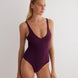 "Model wearing the Agneta Prune/Bordeaux reversible bodysuit from the front, showcasing its scoop neckline and body-hugging fabric."