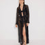 Front View: Model in Aitana Black Kaftan - MOEVA Luxury Swimwear, Loose Fit, Self-Tie Belt, Long-Sleeved, Chain Knitted Fabric, MOEVA Luxury Swimwear