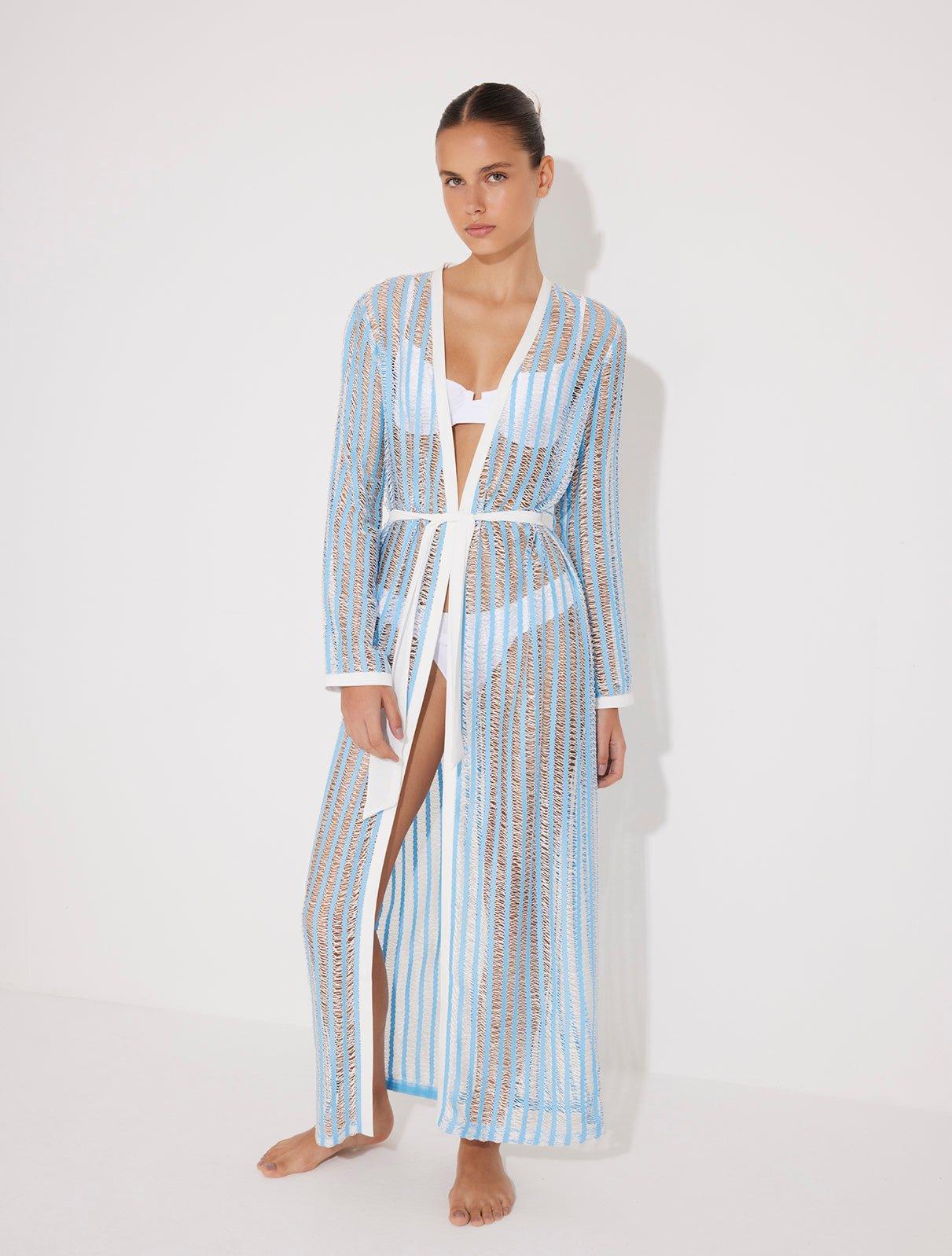 "Front view of the Aitana Blue/White Kaftan, highlighting its ankle-length design, long sleeves, and crisscross knitted pattern. "