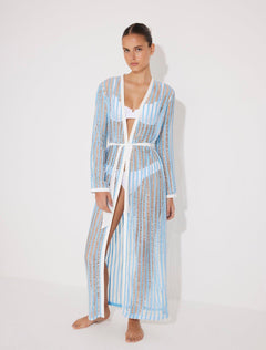 "Front view of the Aitana Blue/White Kaftan, highlighting its ankle-length design, long sleeves, and crisscross knitted pattern. "