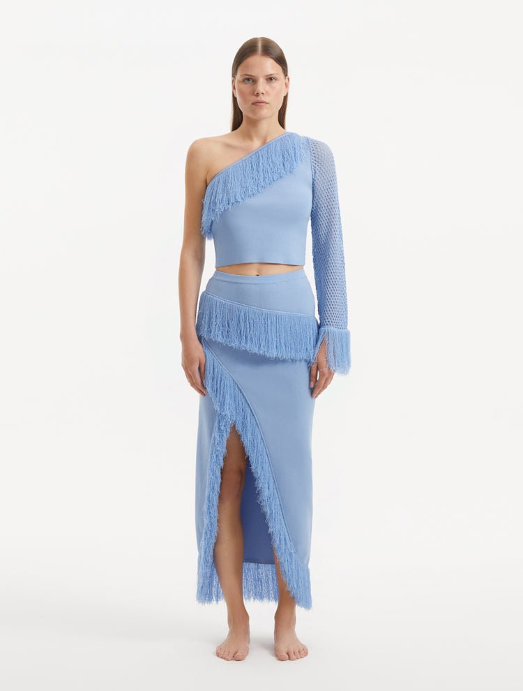 "Model wearing the Alani Baby Blue Skirt from the front, showcasing the high-waisted silhouette and playful fringed hemline."