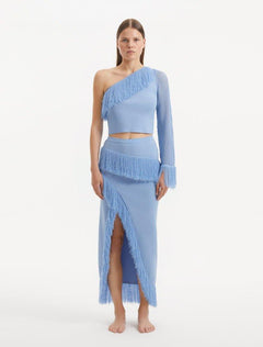 "Model wearing the Alani Baby Blue Skirt from the front, showcasing the high-waisted silhouette and playful fringed hemline."