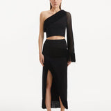 "Model showcasing the Alani Black Skirt from the front, highlighting the elegant high-waisted silhouette and intricate knit texture."