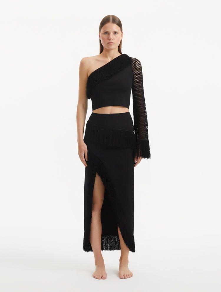 "Model showcasing the Alani Black Skirt from the front, highlighting the elegant high-waisted silhouette and intricate knit texture."