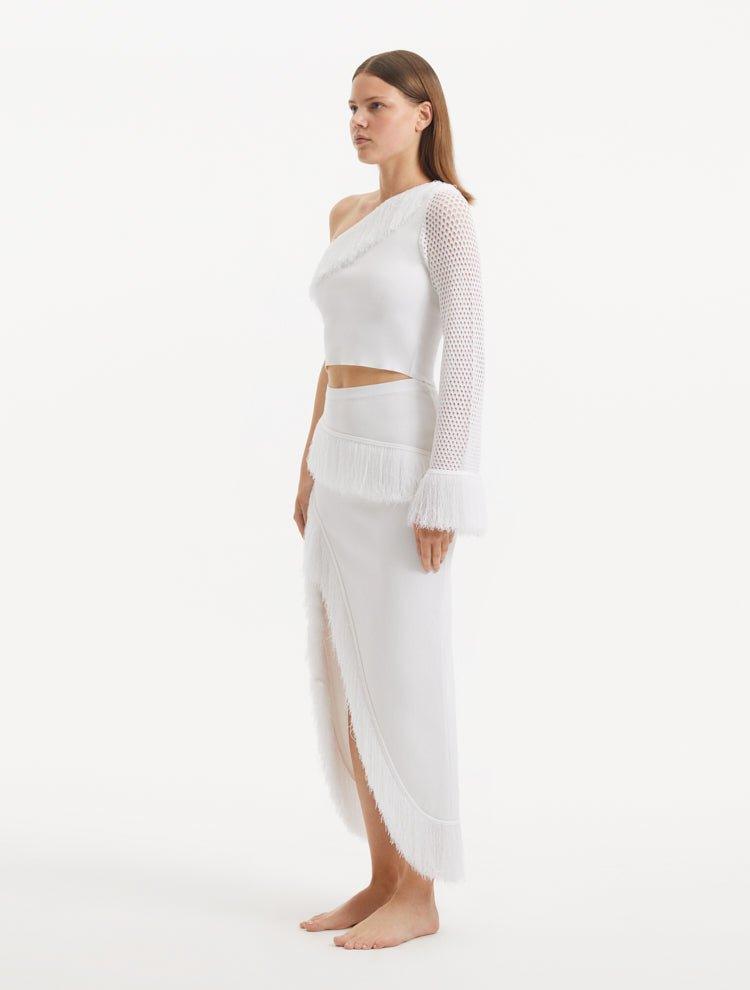 "Side view of the Alani White Skirt, emphasizing the sophisticated design and innovative details that define the garment."