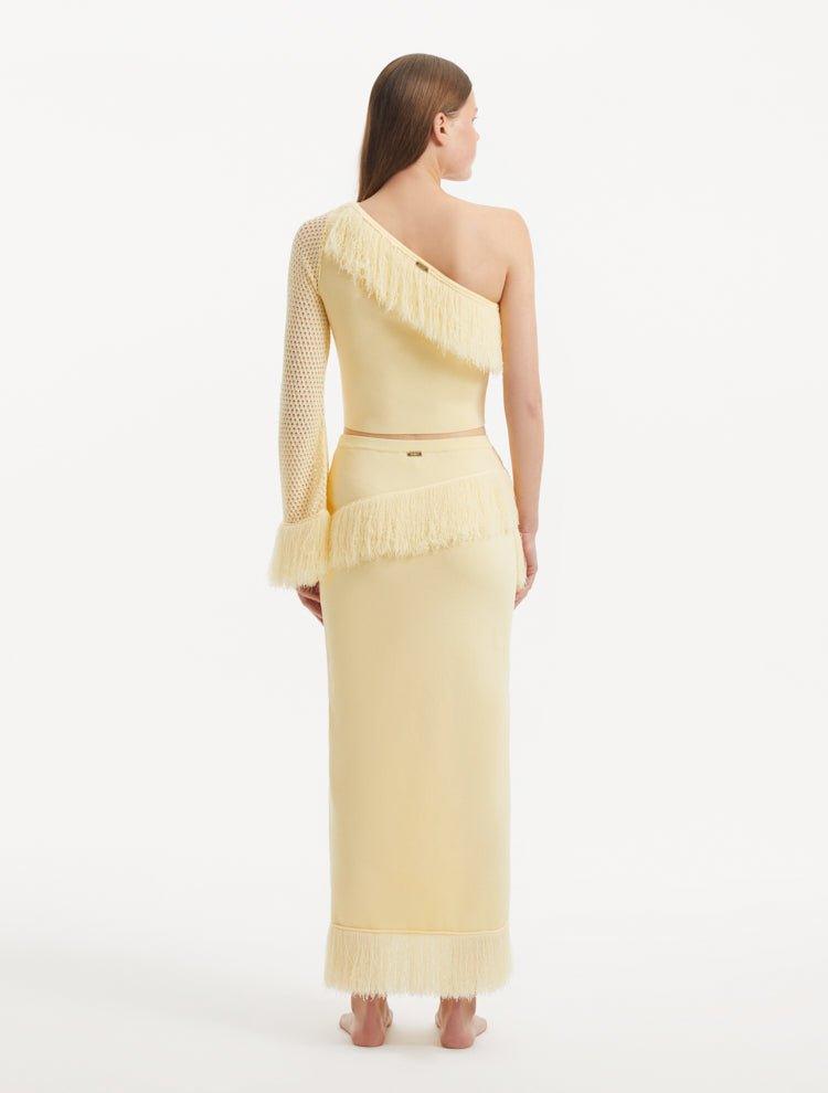 "Back view of the Alani Yellow Skirt, featuring the high-waisted design and showcasing the elegant drape of the knit fabric."