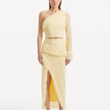 "Model showcasing the Alani Yellow Skirt from the front, highlighting the high-waisted fit, intricate knitwork, and playful fringed hem."