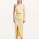 "Model showcasing the Alani Yellow Skirt from the front, highlighting the high-waisted fit, intricate knitwork, and playful fringed hem."