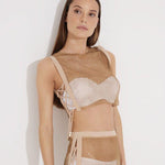 "Model wearing Alejandra Nude Rhinestone Crop Top from the front, highlighting high neck and side tie details."