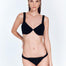 Front View: Model in Alexa Shiny Black Bikini Top - MOEVA Luxury Swimwear, Underwired Top, V Neck, MOEVA Luxury Swimwear