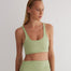 "Front view of a model wearing Alva Green/Nude Crop Top, showcasing the scoop neckline and sleek fit."