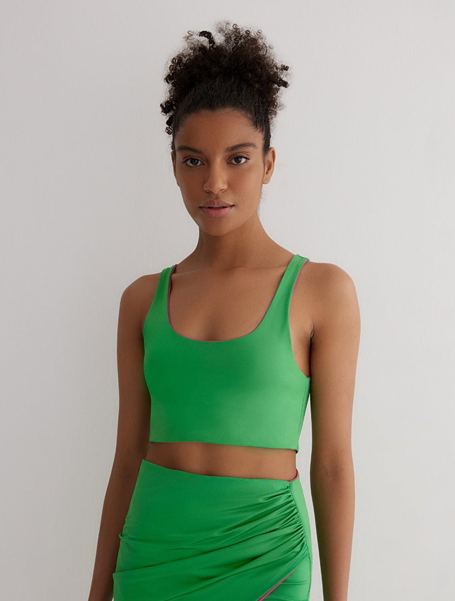 Front View: Model in Alva Green/Pink Reversible Top - MOEVA Luxury Swimwear, Ready to Wear	Top, Fully Lined, Comfort and Sportive, Reversible Stretchy Fabric, MOEVA Luxury Swimwear