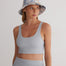 "Front view of a model wearing Alva Grey/White Crop Top, showcasing the scoop neckline and sleek fit."