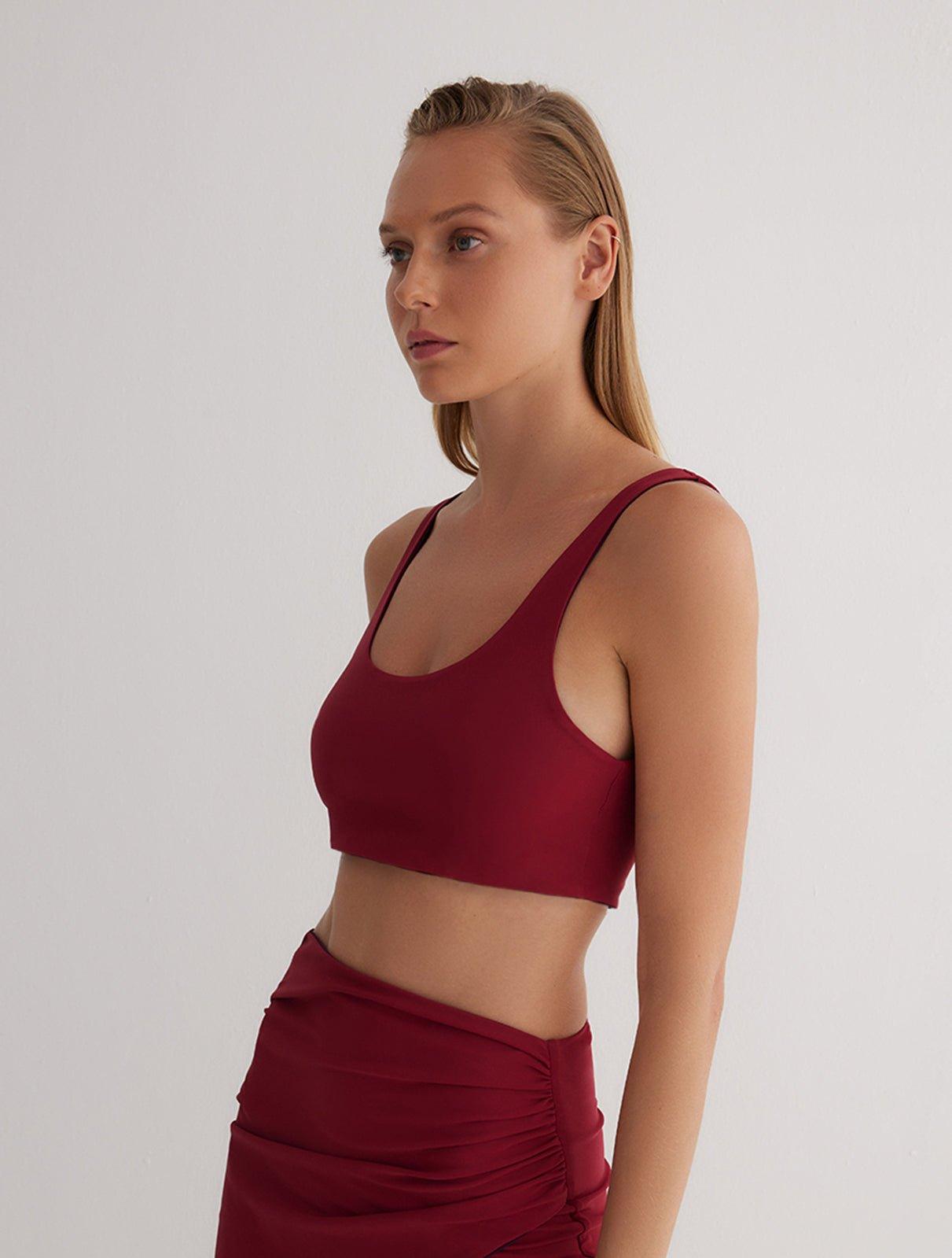 "Front view of a model wearing Alva Prune/Bordeaux Crop Top, showcasing the scoop neckline and sleek fit."