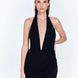 Front View: Model in Antonia Shiny Black Skirt - MOEVA Luxury Swimwear, Wrap Style, Slim Fit, High Rise, Thigh Length Skirt, MOEVA Luxury Swimwear