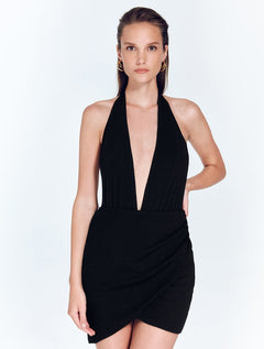 Front View: Model in Antonia Shiny Black Skirt - MOEVA Luxury Swimwear, Wrap Style, Slim Fit, High Rise, Thigh Length Skirt, MOEVA Luxury Swimwear