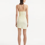 Back view of the Antonia yellow skirt, emphasizing its high-rise cut and smooth drape, illustrating the skirt's comfortable fit and stylish silhouette