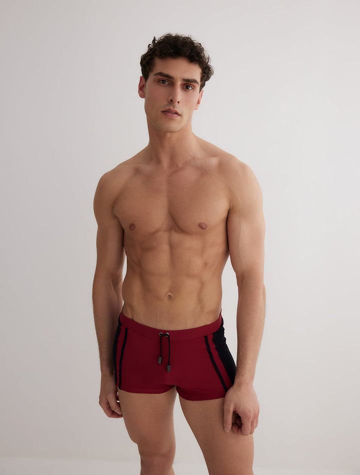 Front View: Model in Antonio Bordeaux/Black Trunks - MOEVA Luxury Swimwear, Duo/Tri-Colored, Elasticated Waistband, Strechy Fabric, Tie at the Front, Quick Dry, Comfortable Fit, MOEVA Luxury Swimwear