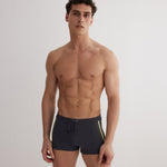 Front View: Model in Antonio Grey/Green/White Men Trunks - MOEVA Luxury Swimwear, Duo/Tri-Colored, Elasticated Waistband, Strechy Fabric, Tie at the Front, Quick Dry, Comfortable Fit, MOEVA Luxury Swimwear